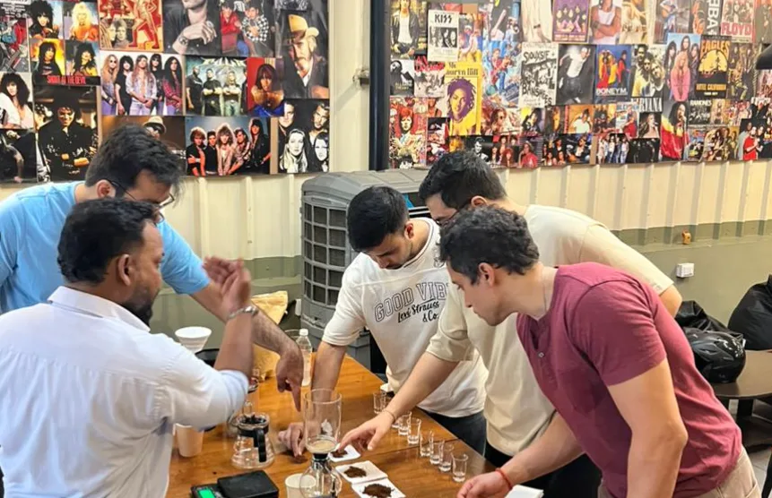 Guests learning about coffee together around a tasting table.