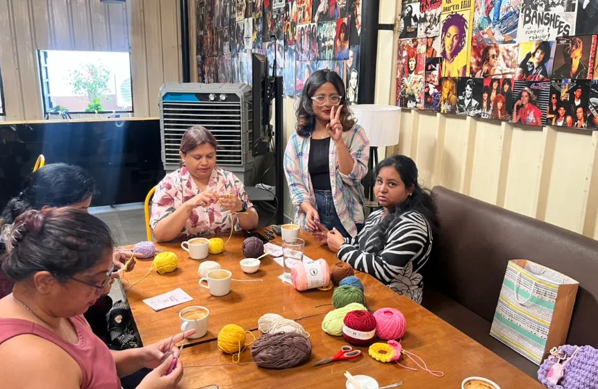 Guests sharing a craft activity around a table with coffee.